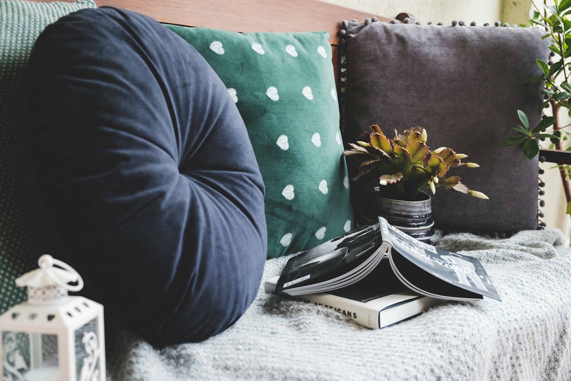 How to Create a Cozy Reading Nook Two books beside three assorted color pillows